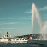 white ship on water fountain under blue sky during daytime